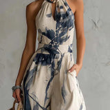 Silvia | Jumpsuit met halternek, abstracte print en wijde pijpen