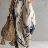 Silvia | Jumpsuit met halternek, abstracte print en wijde pijpen