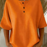 Top met wafelpatroon en knopendetail voor een ontspannen look